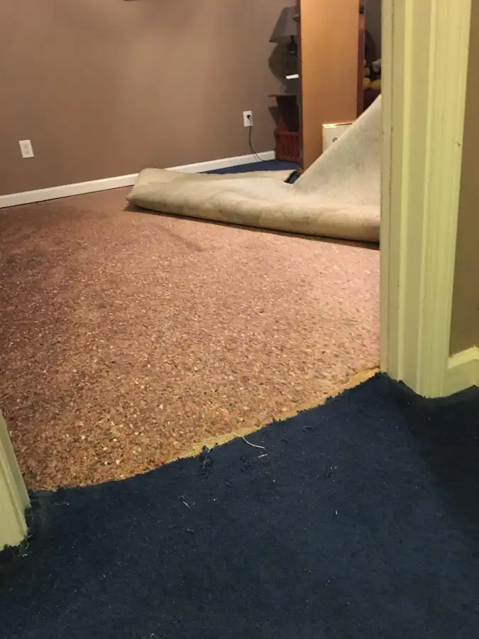 Carpet pad removal revealing water damage during Water Mitigation Services in Peach Bottom